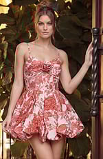 Detailed view of a corset-style bodice with vertical boning and sheer mesh panels on the back of a floral mini dress.