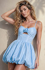 High-waisted blue cocktail dress with a vintage-inspired rosette detail and modern sheer back panels.