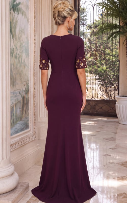 Sophisticated plum evening gown featuring waist ruching and ornate gold floral sleeve accents.