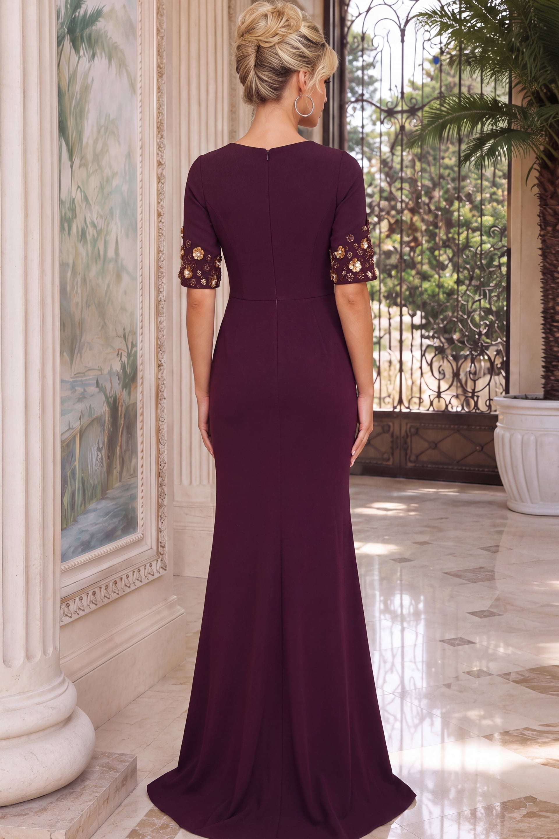 Sophisticated plum evening gown featuring waist ruching and ornate gold floral sleeve accents.