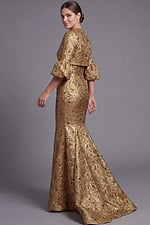 Formal gold gown with flared sleeves and fitted silhouette