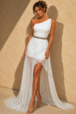 white one shoulder pleated mini dress with beaded silver belt and tulle train
