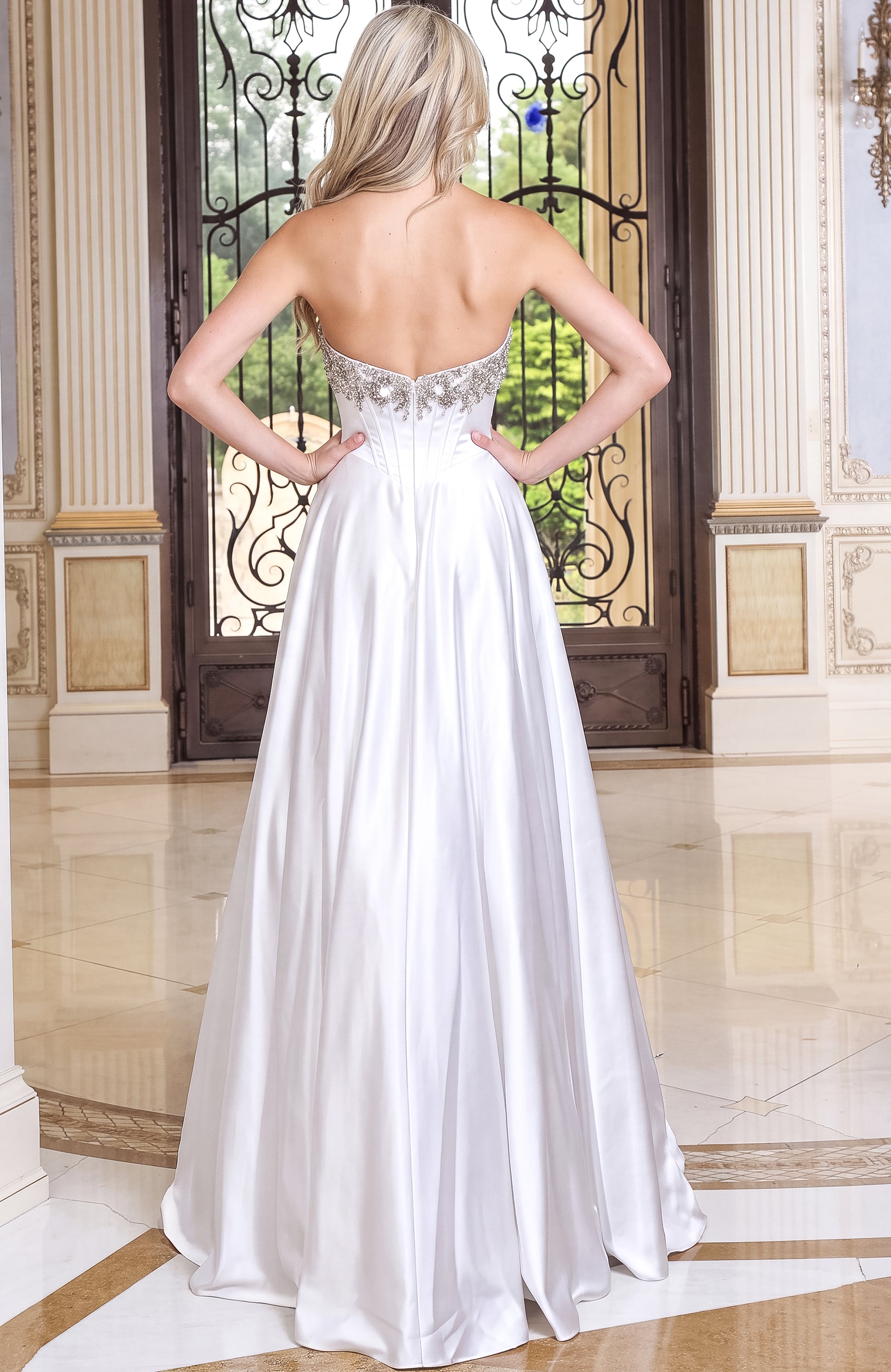 back view of white satin strapless ball gown gown with corset bodice and beaded bustline