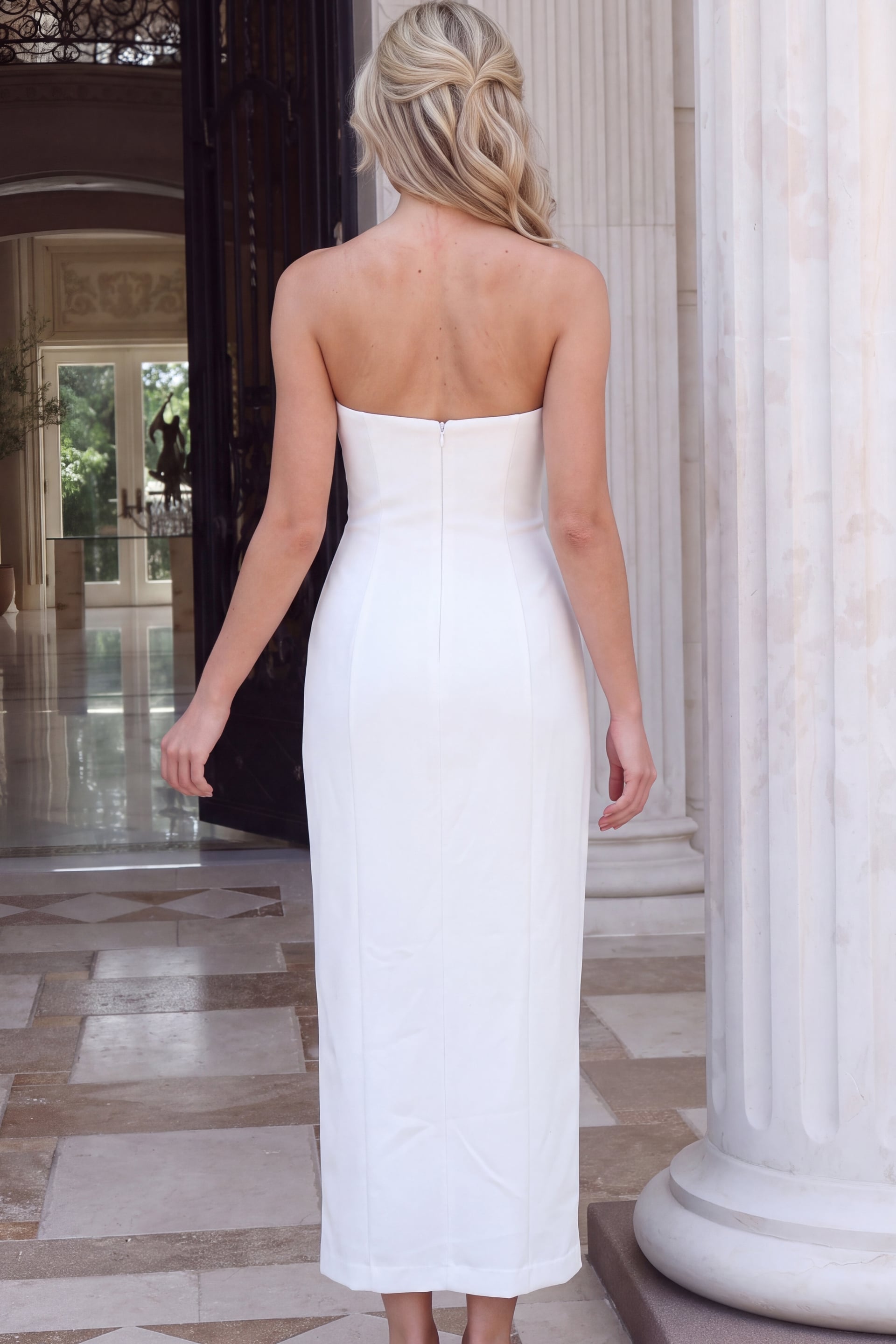 Back view of off white crepe strapless column gown showing the center zip back