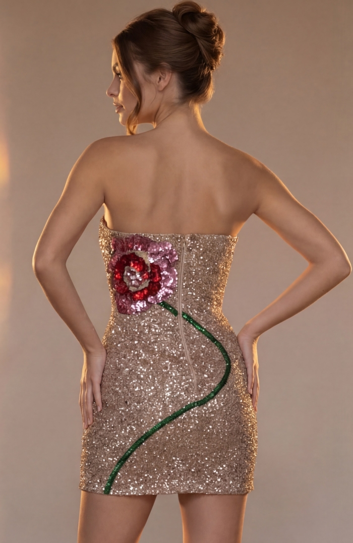 glittering party dress featuring an asymmetric rose vine design and a straight strapless bodice.