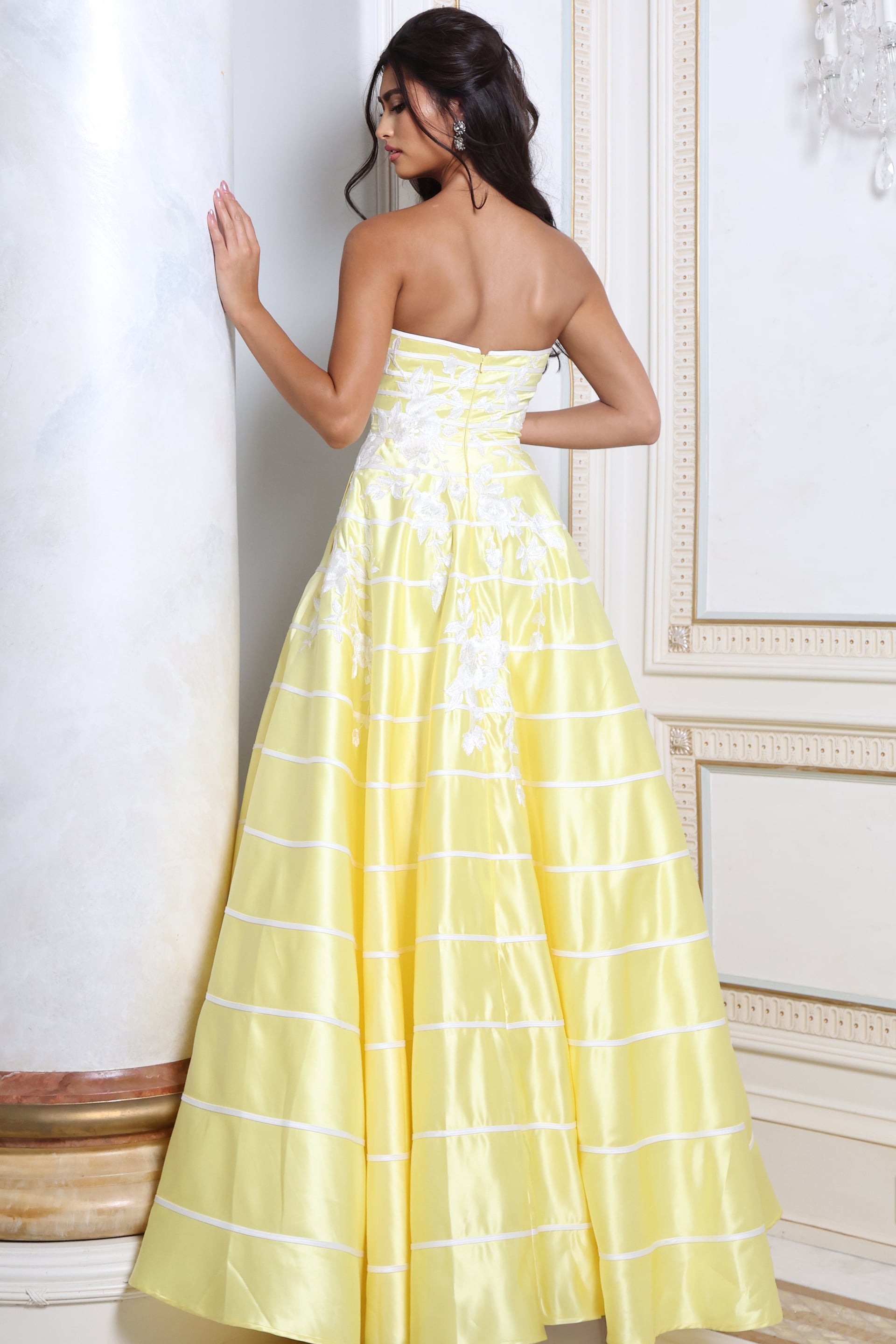 Back view of yellow striped taffeta ball gown showing zip back and full skirt
