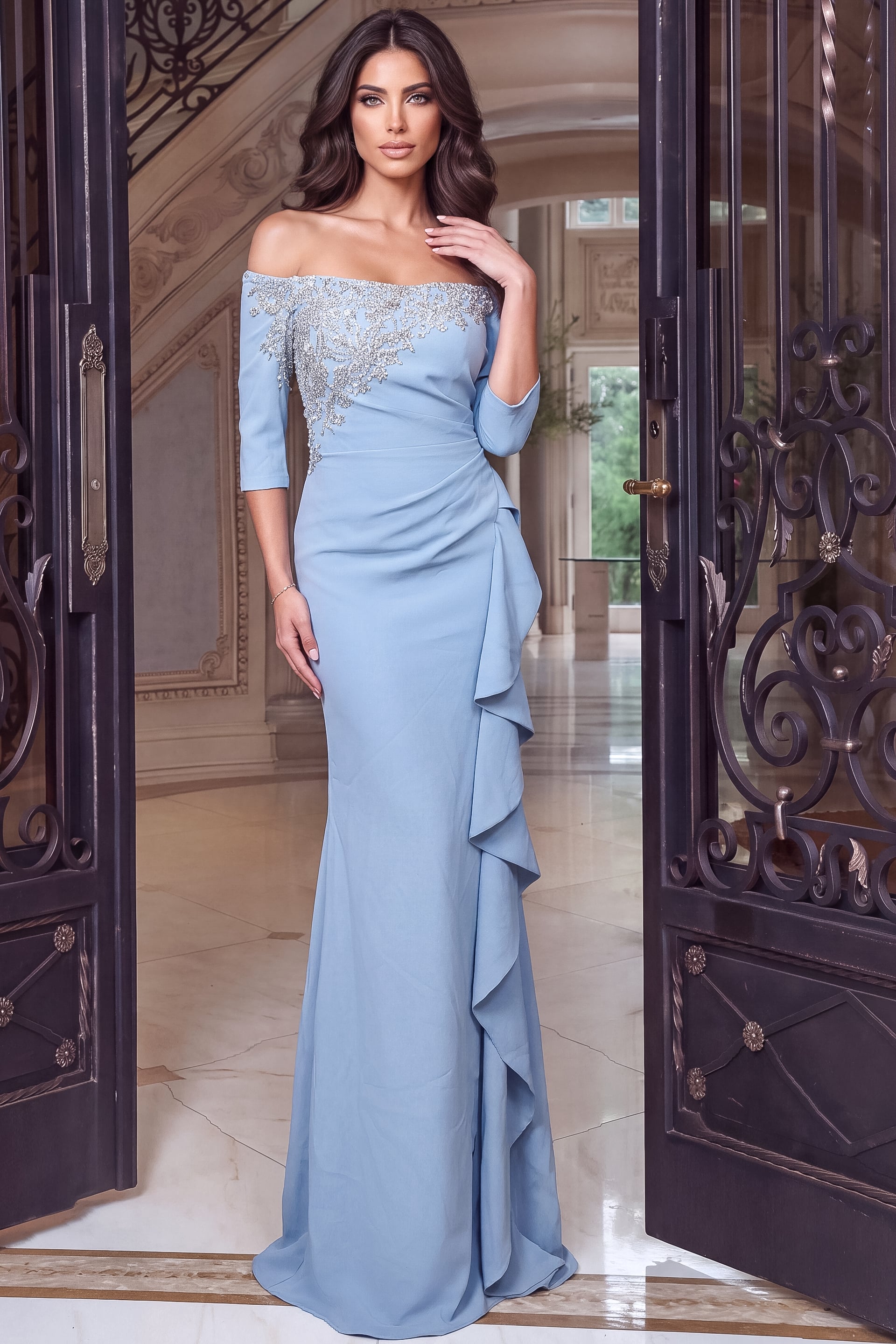 Elbow length sleeves and crystal applique shape this fitted light blue floor length gown