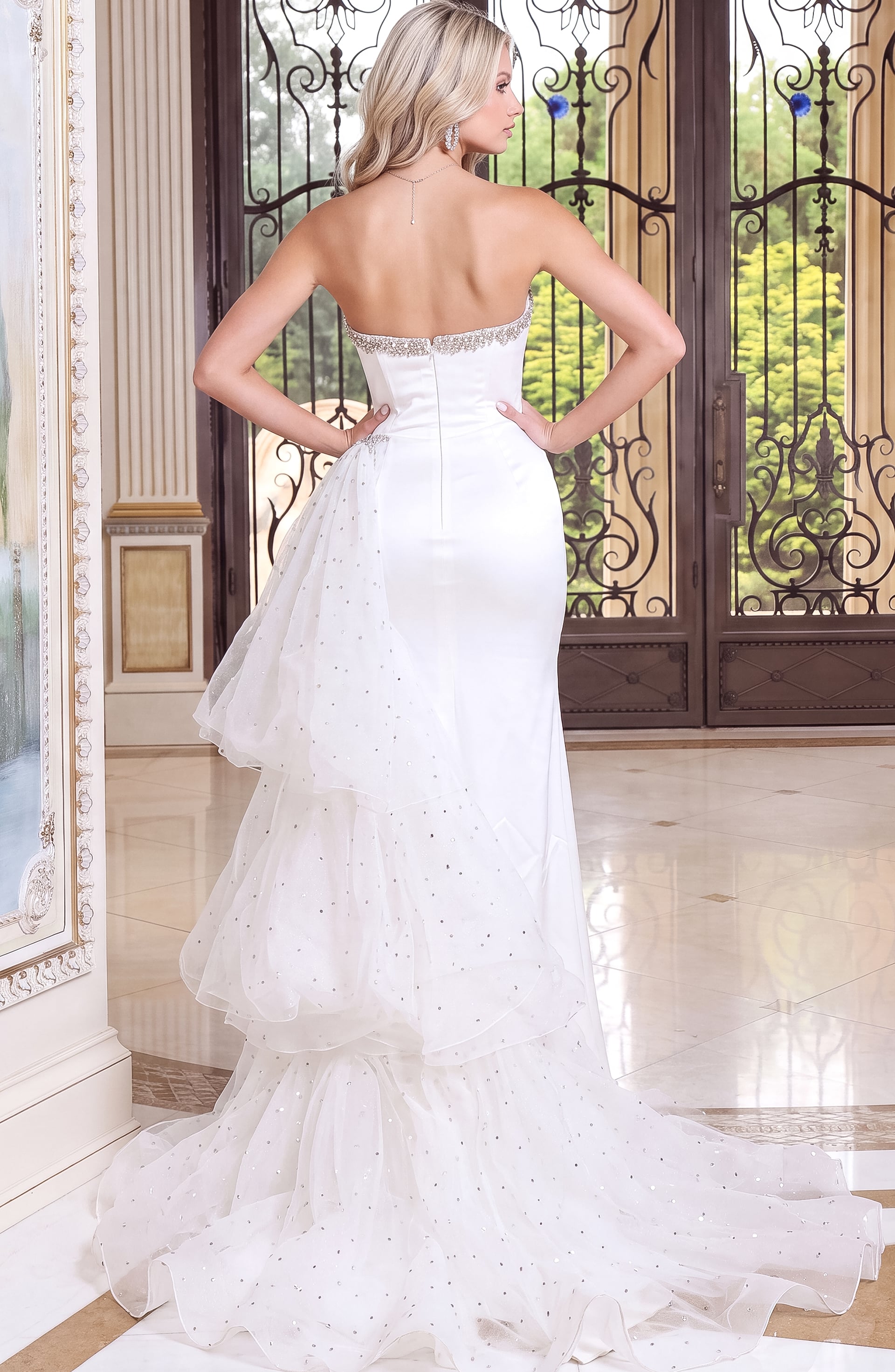 back view of white satin strapless sheath gown with high slit and beaded neckline