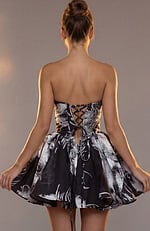 Back view of a black and white printed party dress featuring a corset-style lace-up closure.