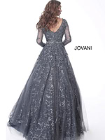 Model showcasing the back of Jovani 51838 gunmetal gray gown with V-shaped back and intricate embellishments.