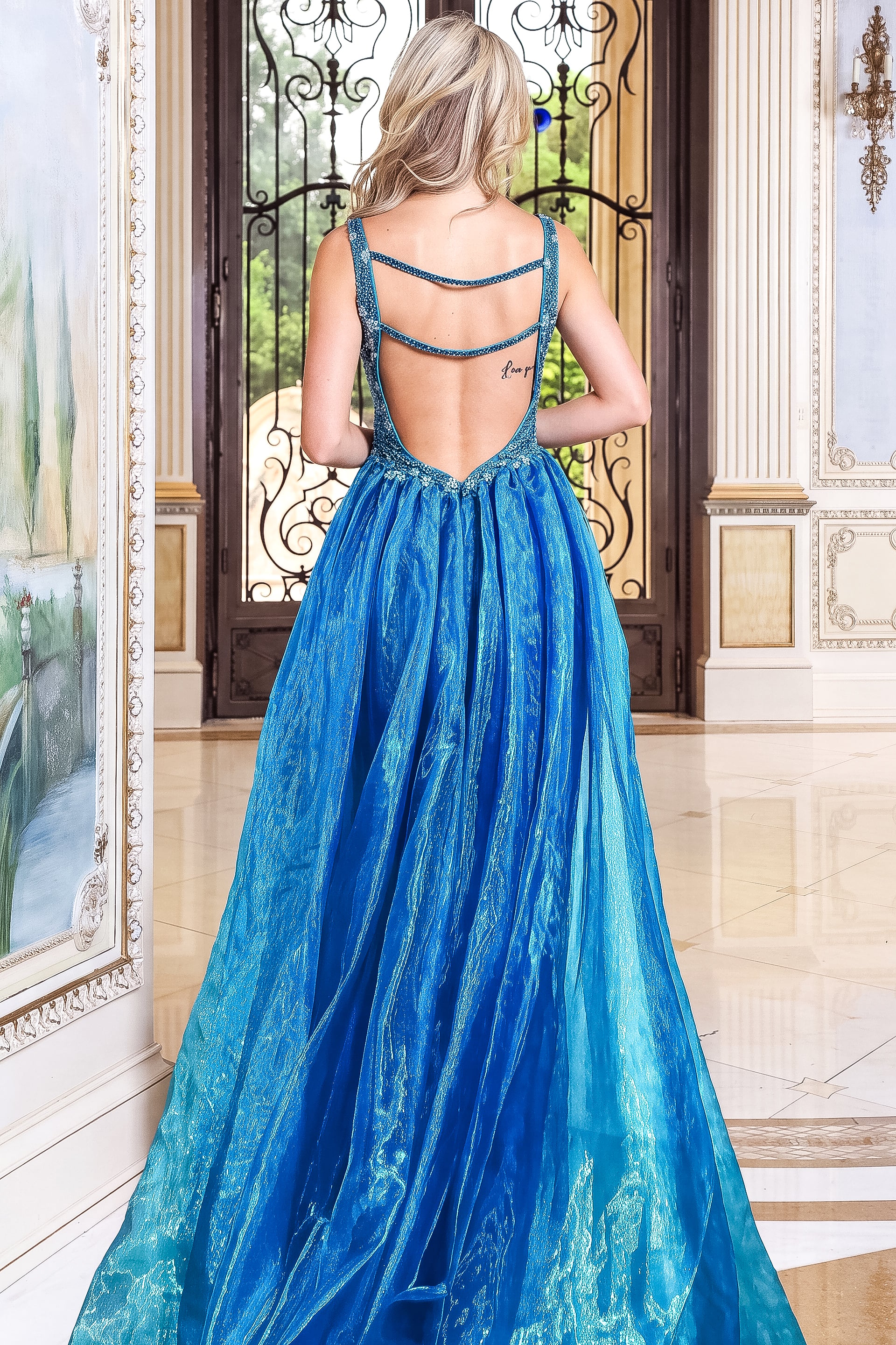 back view of royal blue beaded v neck sheath gown with detachable overskirt and plunging v neck