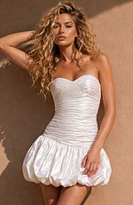 Fit-and-flare silhouette in a high-shine iridescent fabric with a cinched waist and a dramatic, rounded bottom.