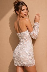 Form-fitting party dress with a structured corset bodice, exposed boning, and matching elbow-length lace gloves covered in tiny white flowers.