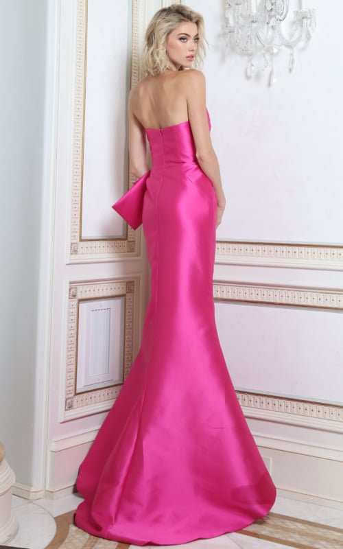 Back view of fuchsia satin trumpet gown showing cascading sash and sweep train