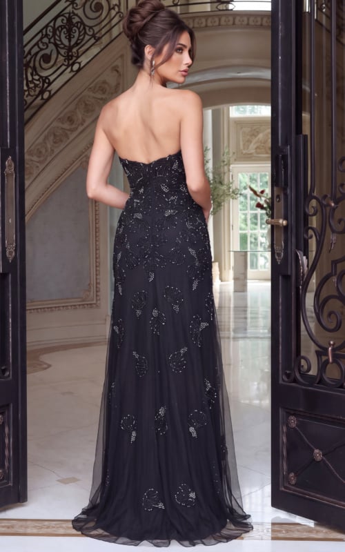 Photographed from behind, a black beaded tulle gown with bare back and soft train