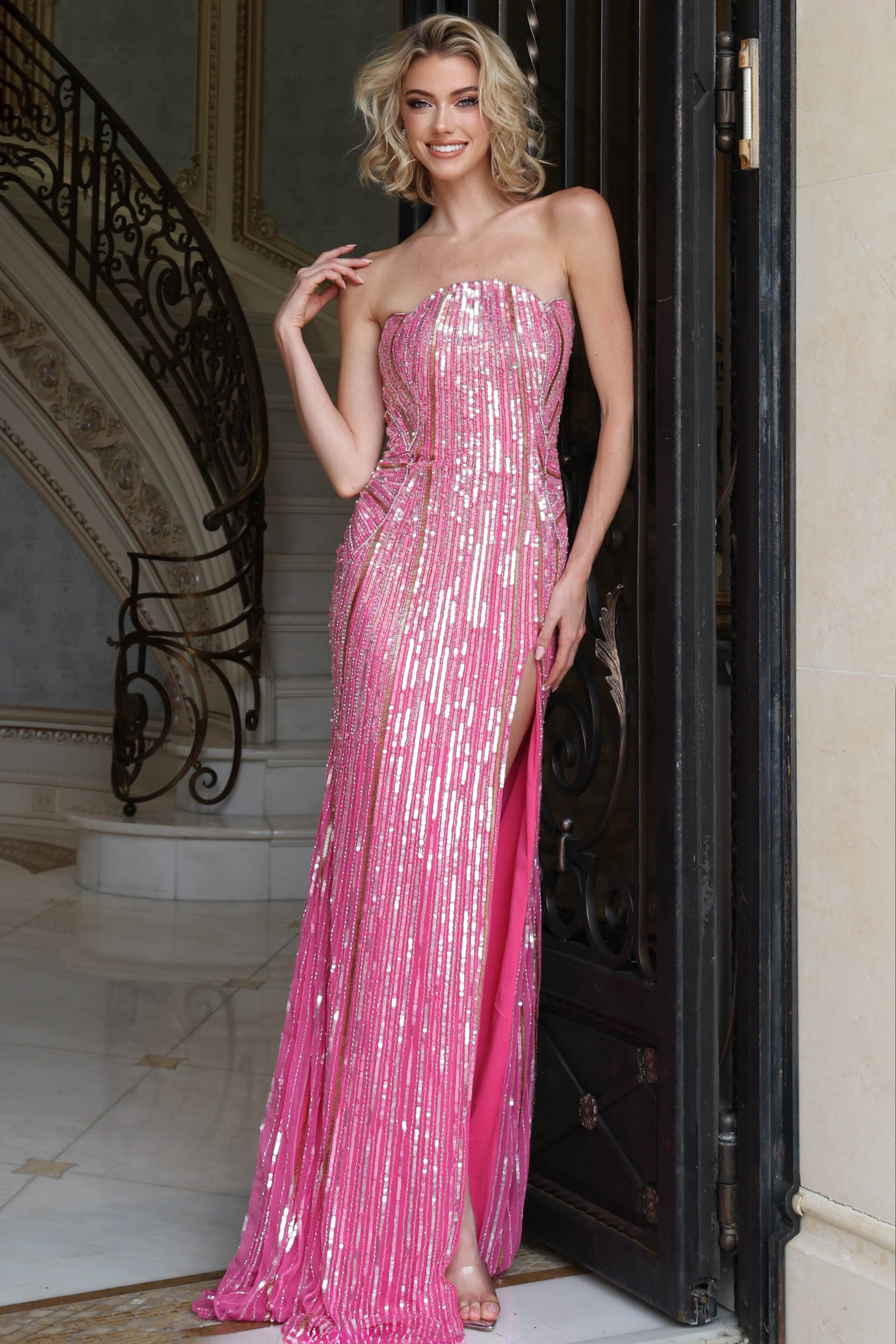 Pink sequin strapless column gown shown with hand at the bodice, front view