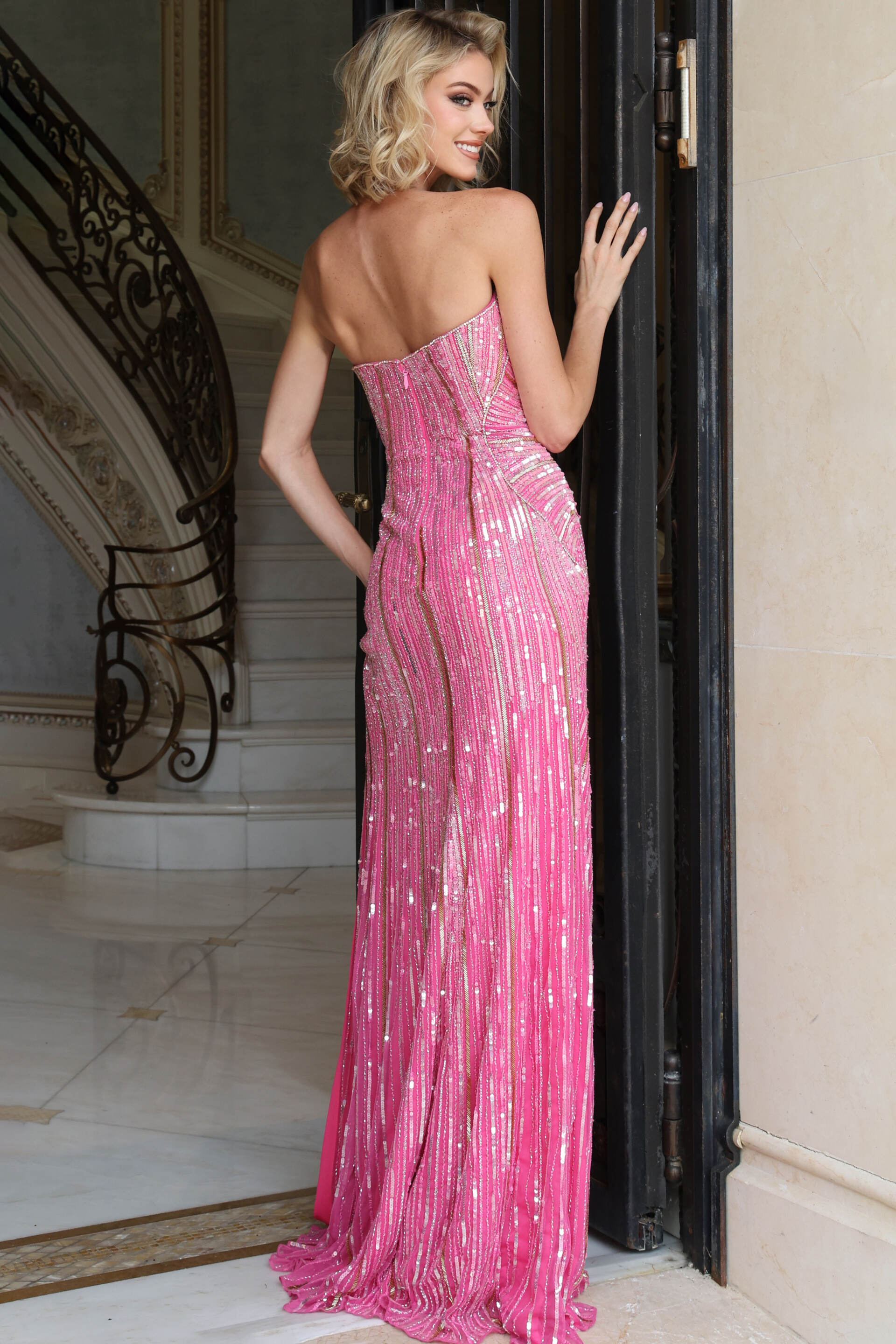 Back view of pink sequin column gown showing zip back and sweep train