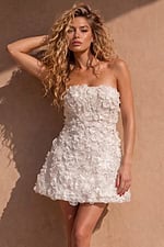 strapless white mini dress covered in three-dimensional floral appliqués.