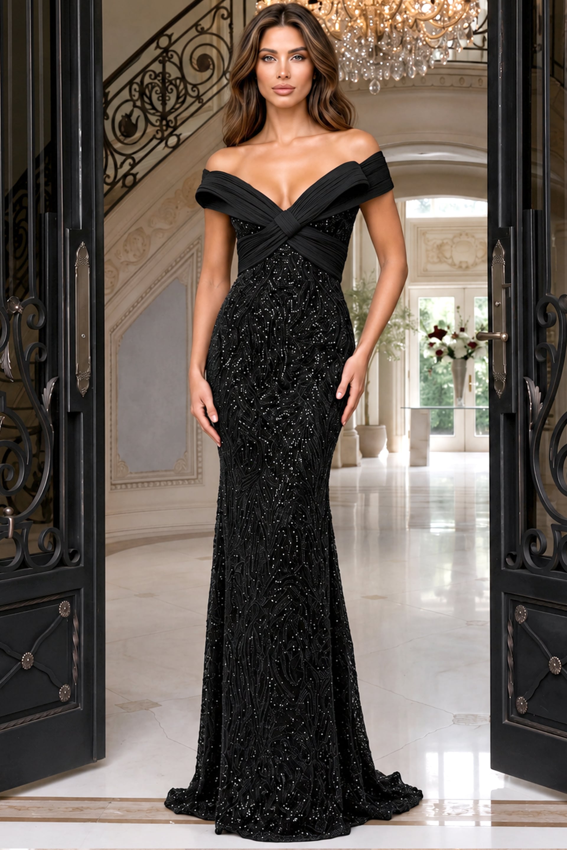 Model in a black beaded mermaid gown with off shoulder folds and plunging V