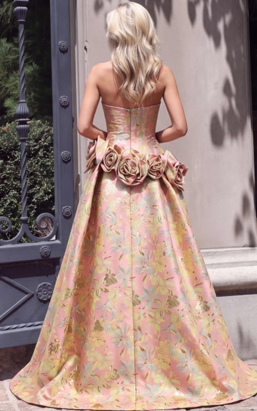Back view of blush floral jacquard gown showing rose appliques and overskirt train