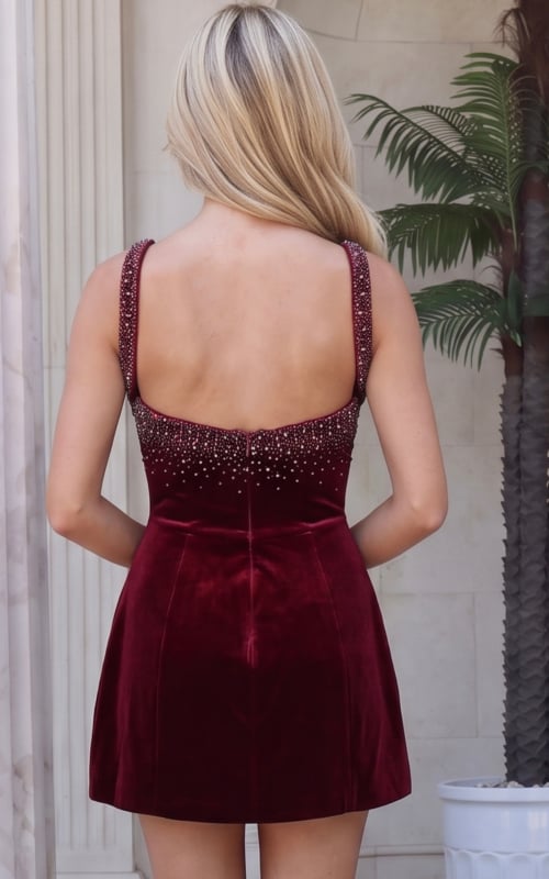 Back view of burgundy velvet mini dress showing the open back and crystal trimmed straps