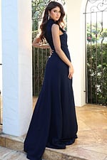Jovani 53168 navy sleeveless high neck jumpsuit back view showing floral applique at the neckline, open back cutout, and flowing wide leg pants with sweep train