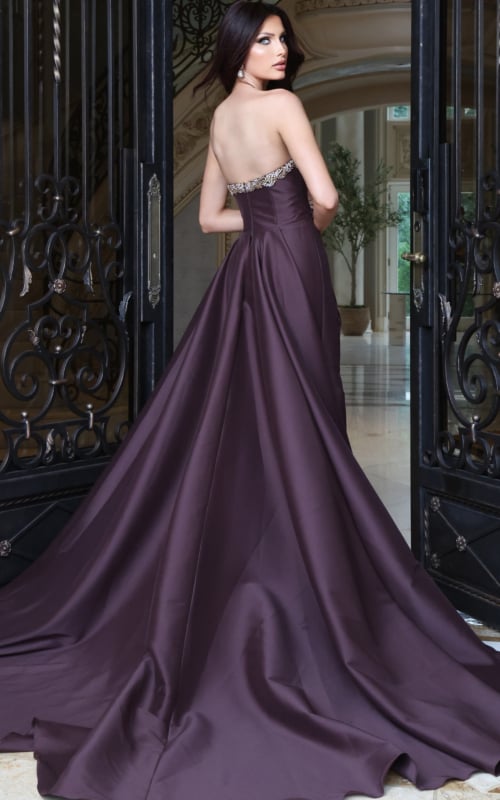 Deep aubergine satin ball gown with beaded strapless bodice and long train, side view