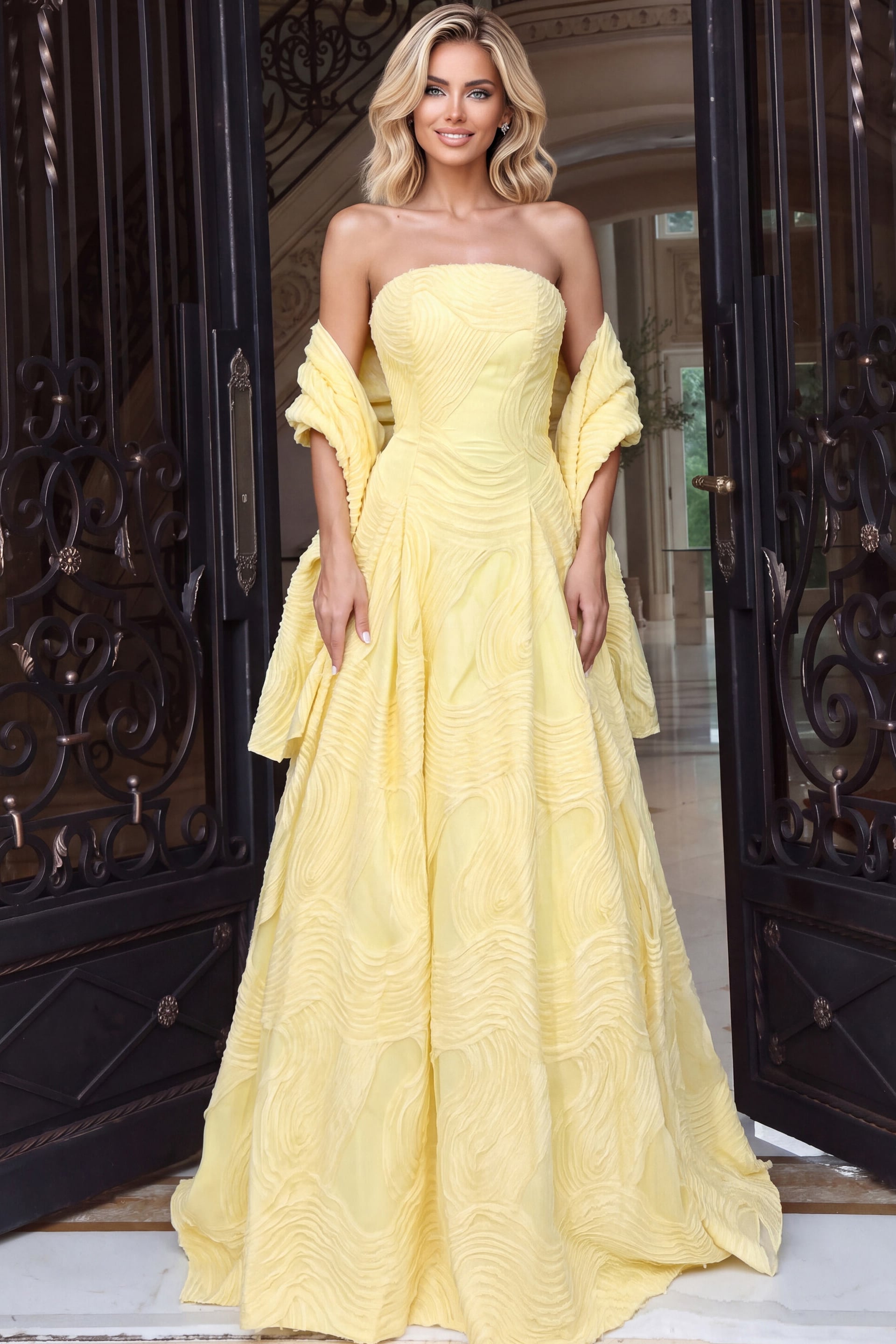 Buttercup yellow A-line gown with an off-the-shoulder wrap and full textured skirt sweeping the floor