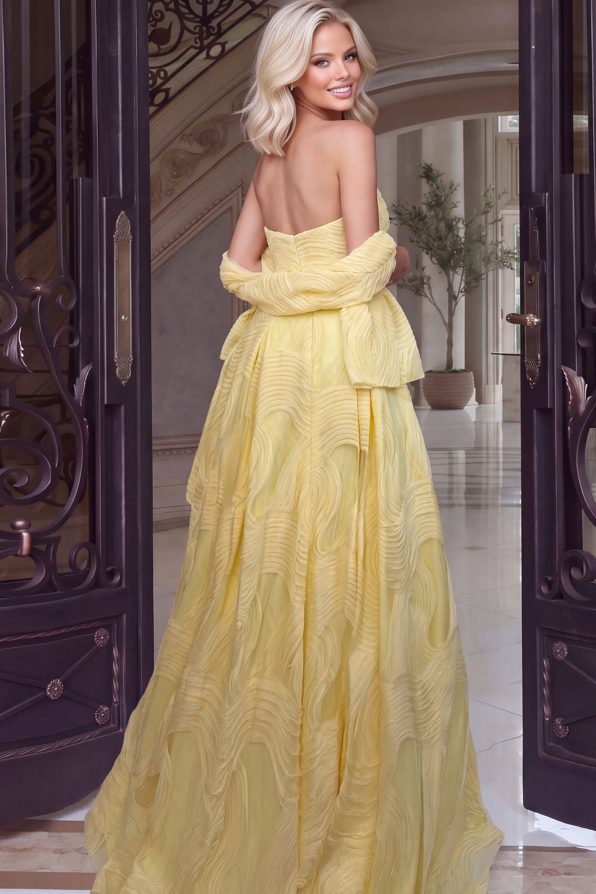 Bare-backed buttercup gown shown from behind with off-shoulder wrap and sweeping textured train