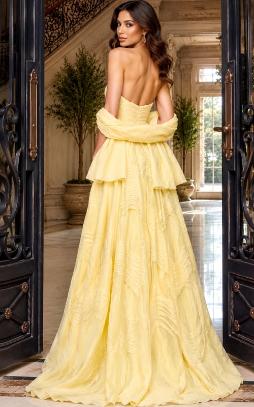 Cascading layers and a bare back on a pastel yellow ball gown, model turned away
