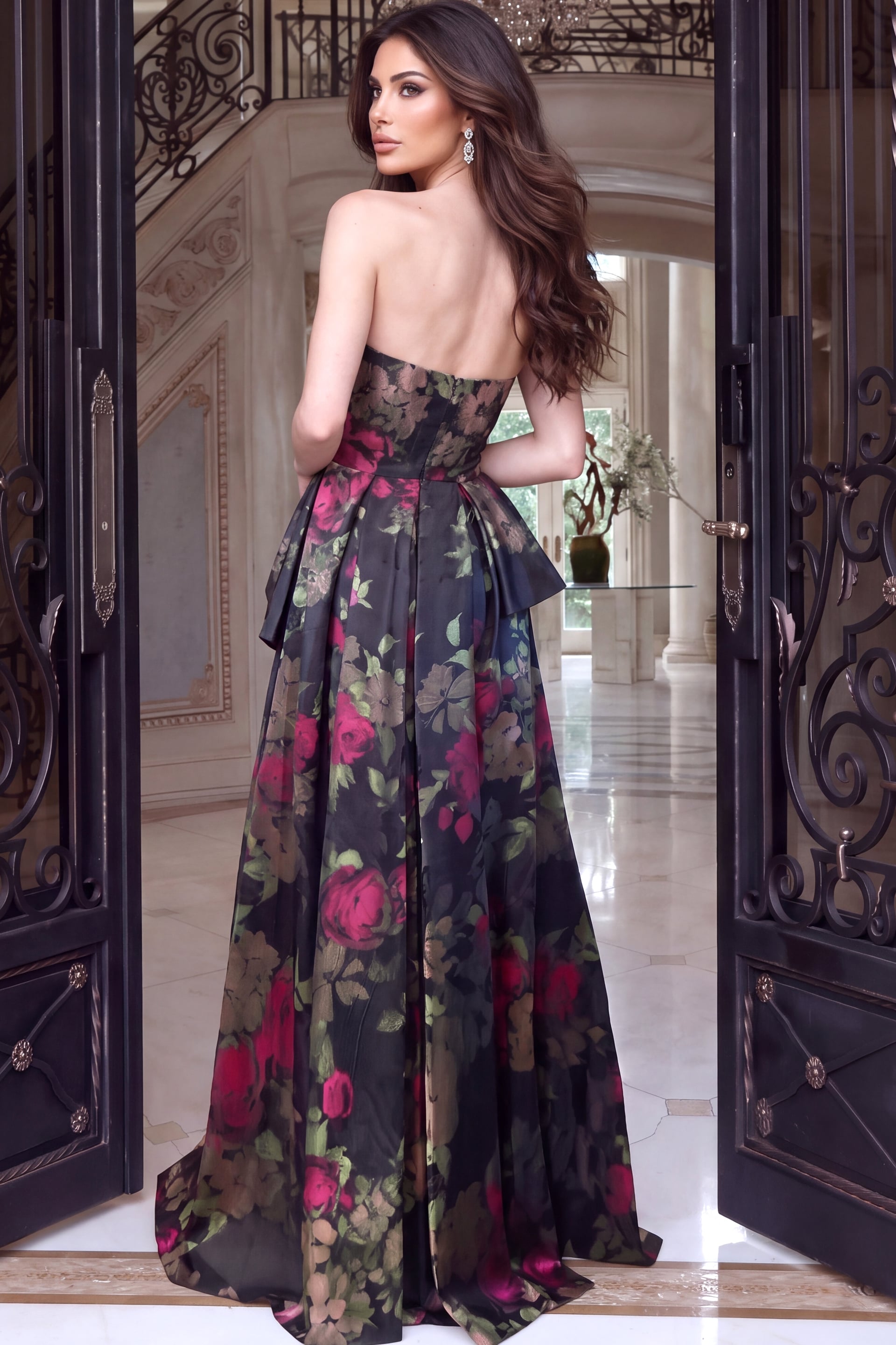 Rear angle showing an open back floral gown with peplum drape and pleated skirt