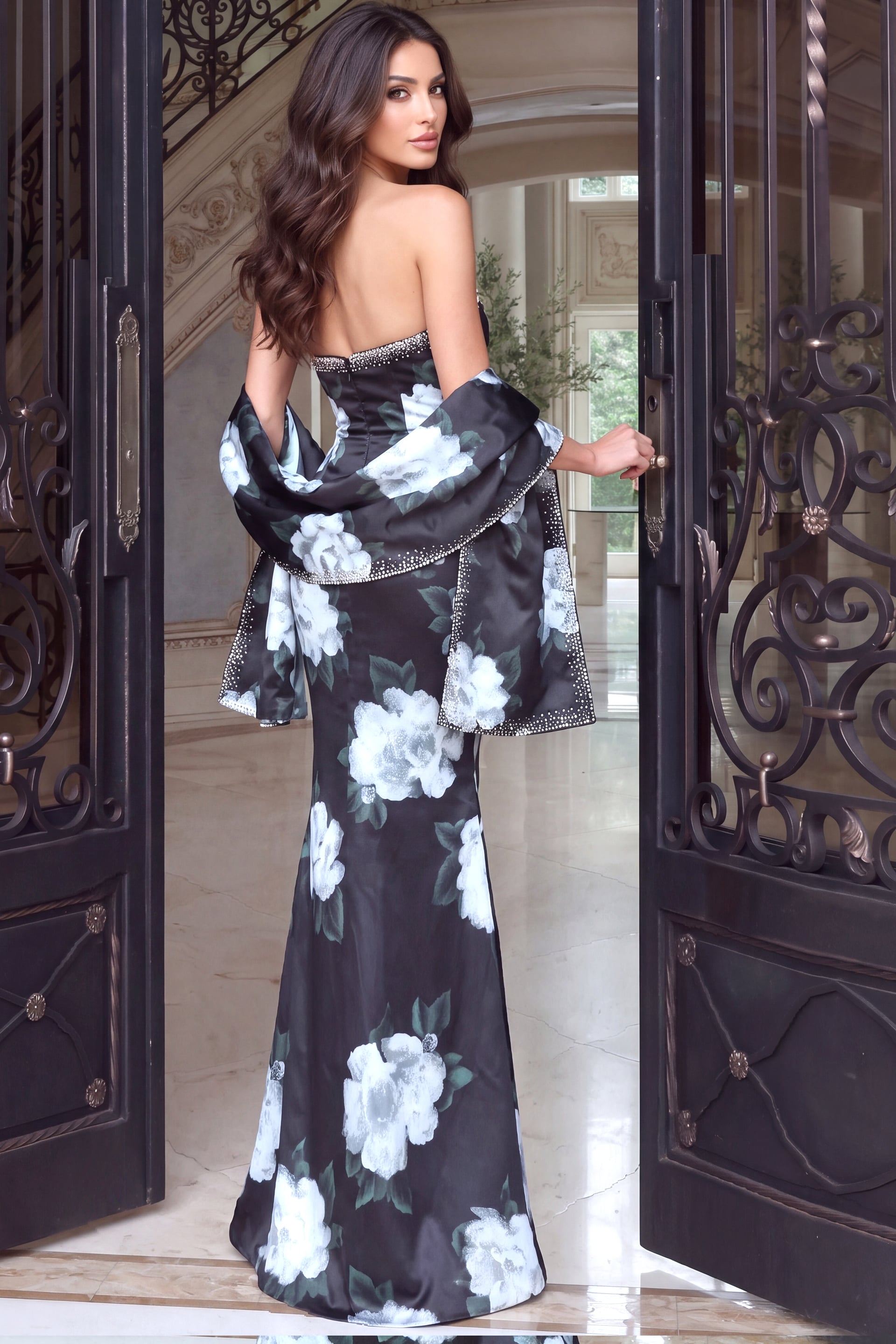 Viewed from the back, a fitted floral satin gown with crystal trimmed shawl