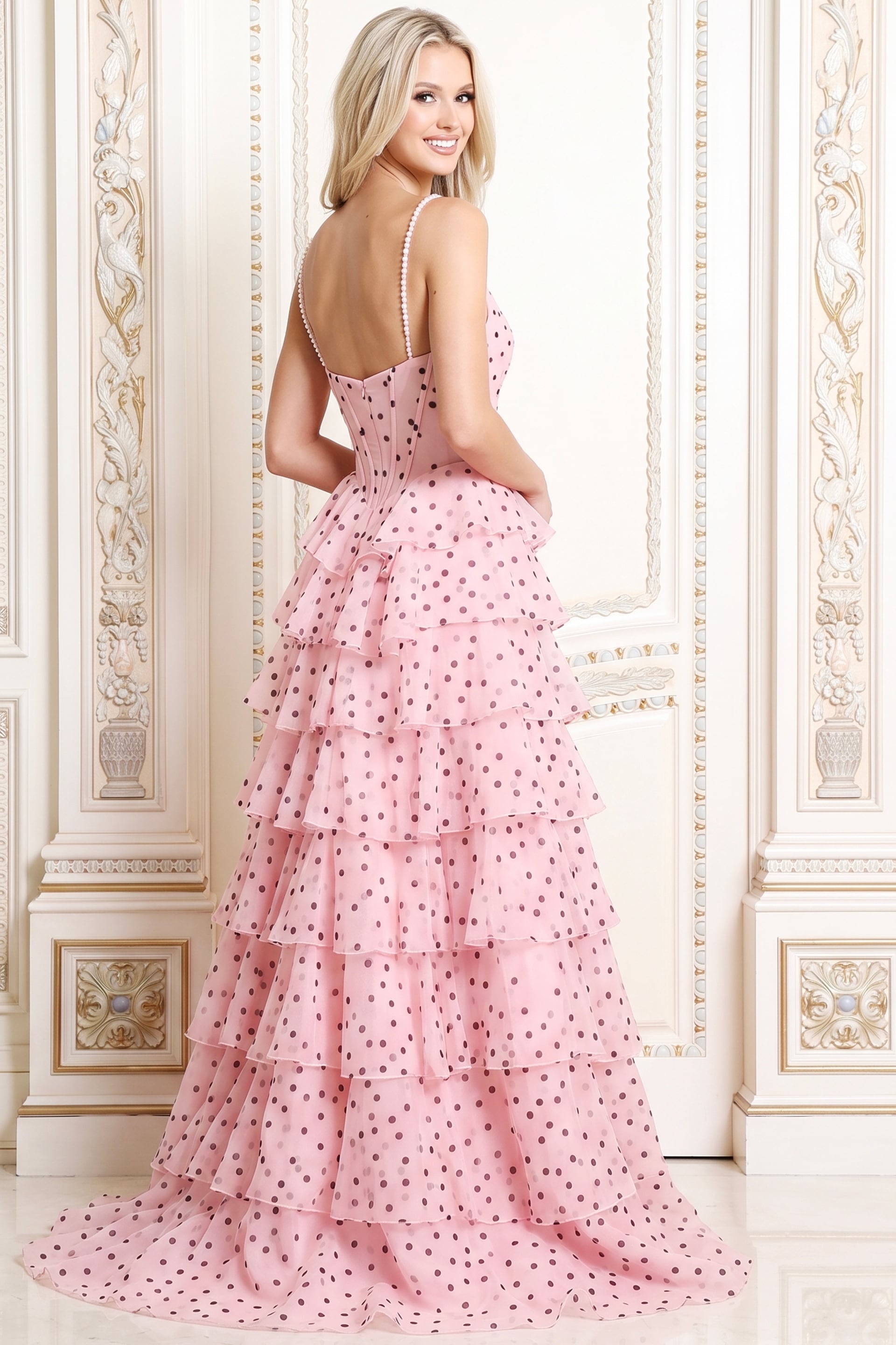 Back view of pink polka dot tulle ball gown showing the corset back and tiered skirt