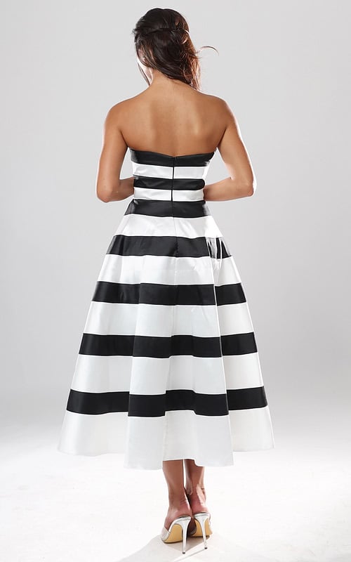 back view of black and white striped strapless A-line midi dress with straight neckline and pleated skirt, Jovani style 53462