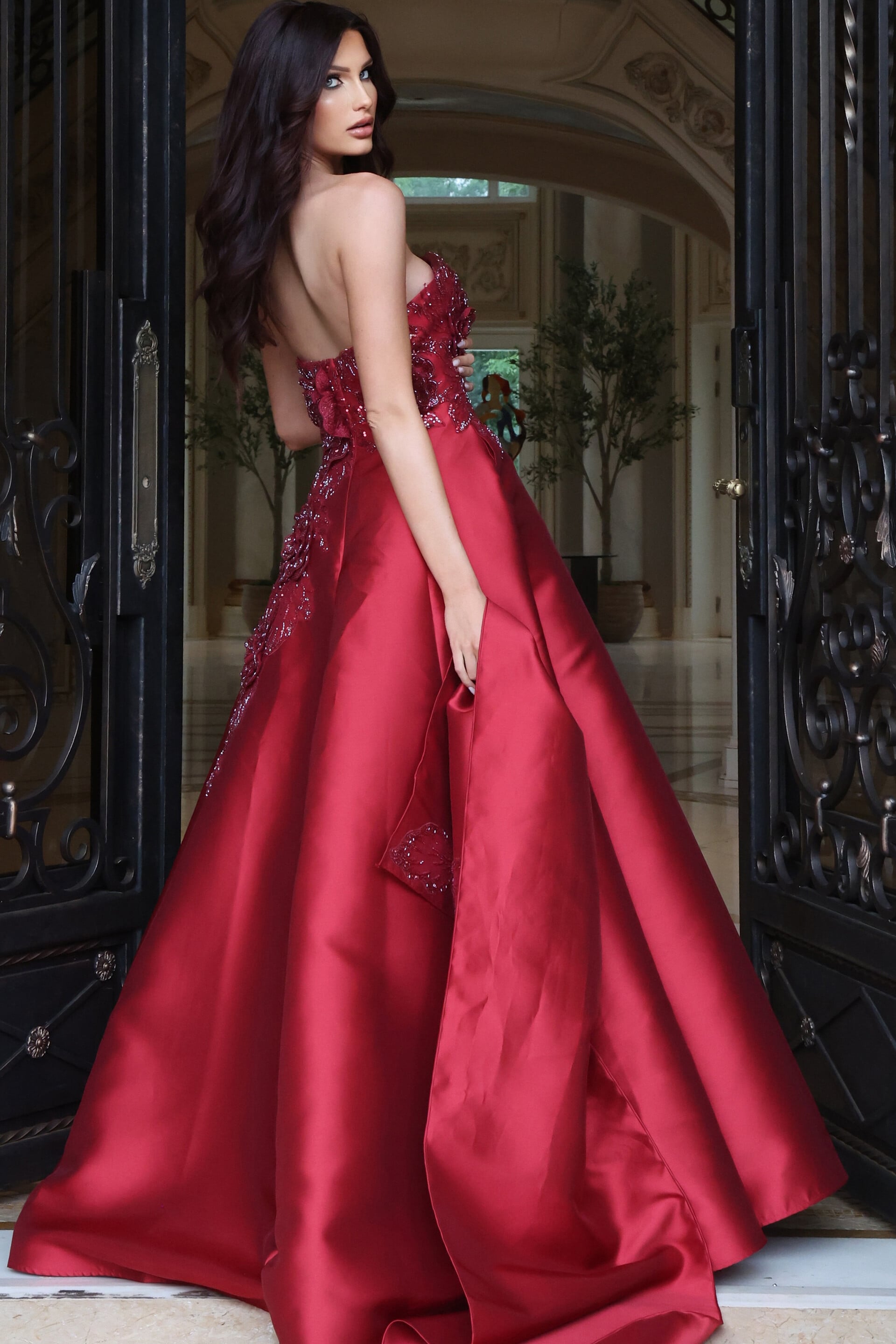 Crimson satin ball gown with beaded strapless bodice and full skirt, side view