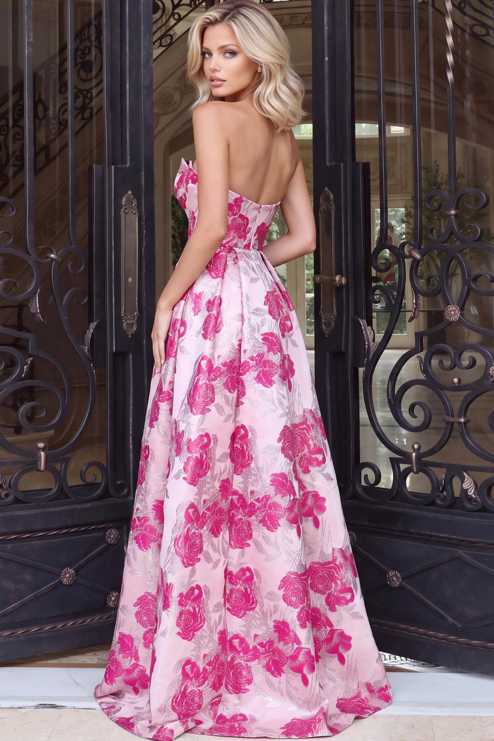 Bare shoulders and a seamed corset bodice on a pink floral jacquard ballgown, seen from behind