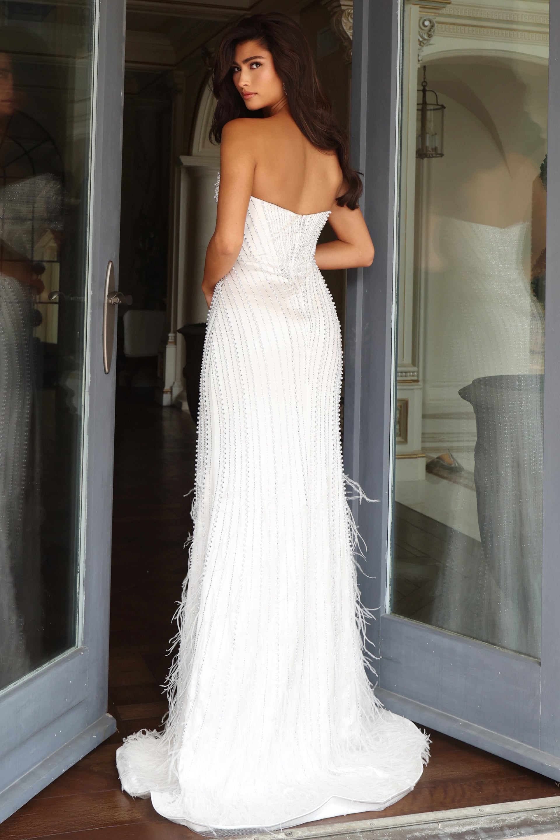 back view of off white beaded mermaid gown with open back, feather fringe and sweep train 53576