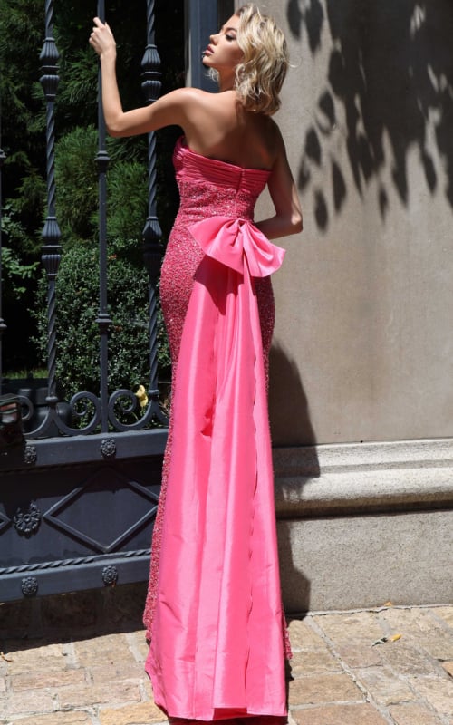 back view of hot pink sequin gown with large satin bow and train