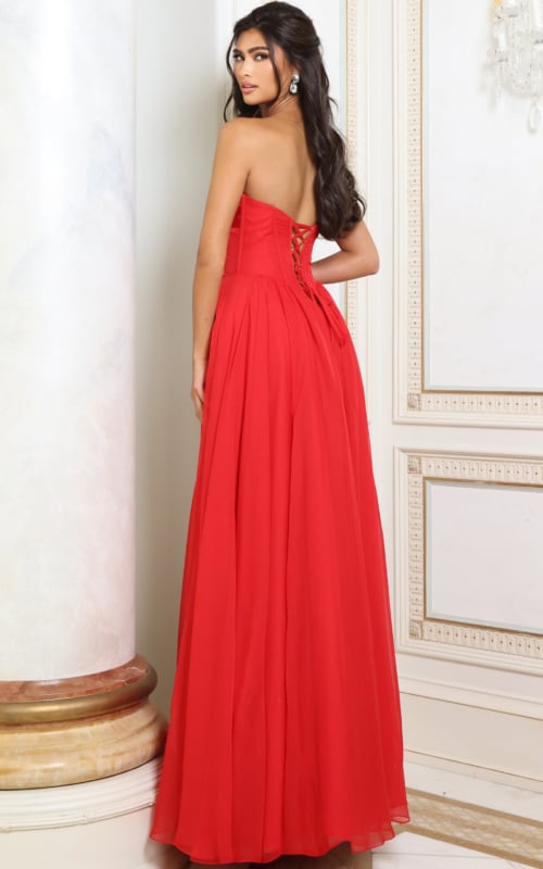 Back view of red chiffon A line gown showing lace-up corset back and flowing skirt