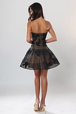 Jovani 53779 back view of black floral applique strapless fit and flare short homecoming dress over nude lining with sheer skirt
