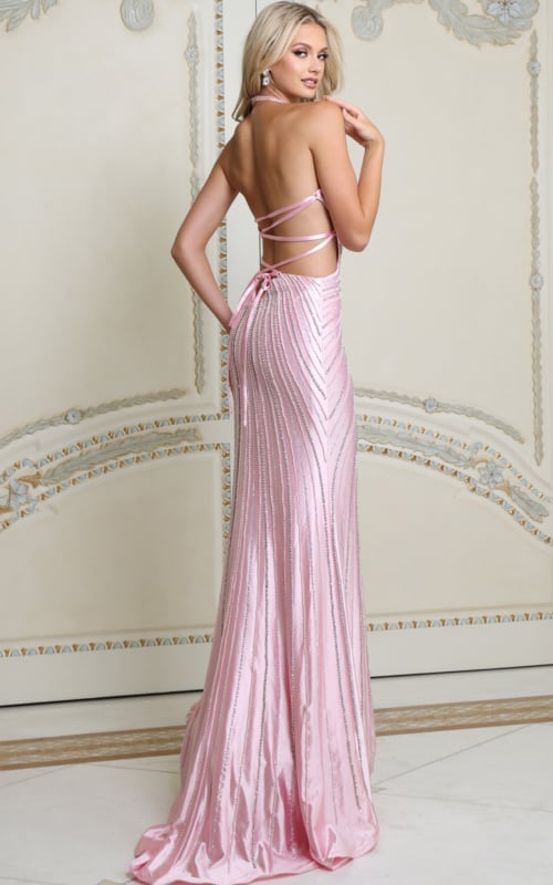 Back view of light pink beaded halter gown showing lace-up open back and sweep train