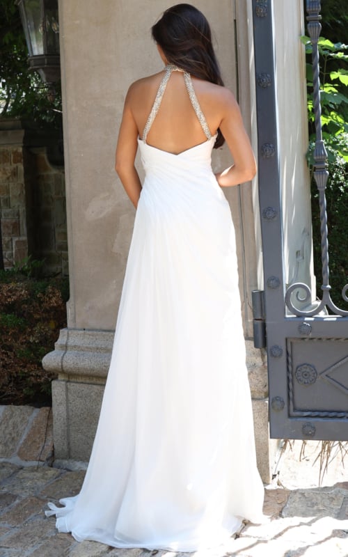 back view of white chiffon halter gown with open back and train