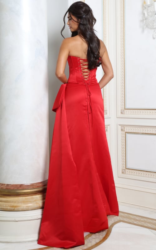 Back view of red satin corset gown showing lace-up back and draped sash train