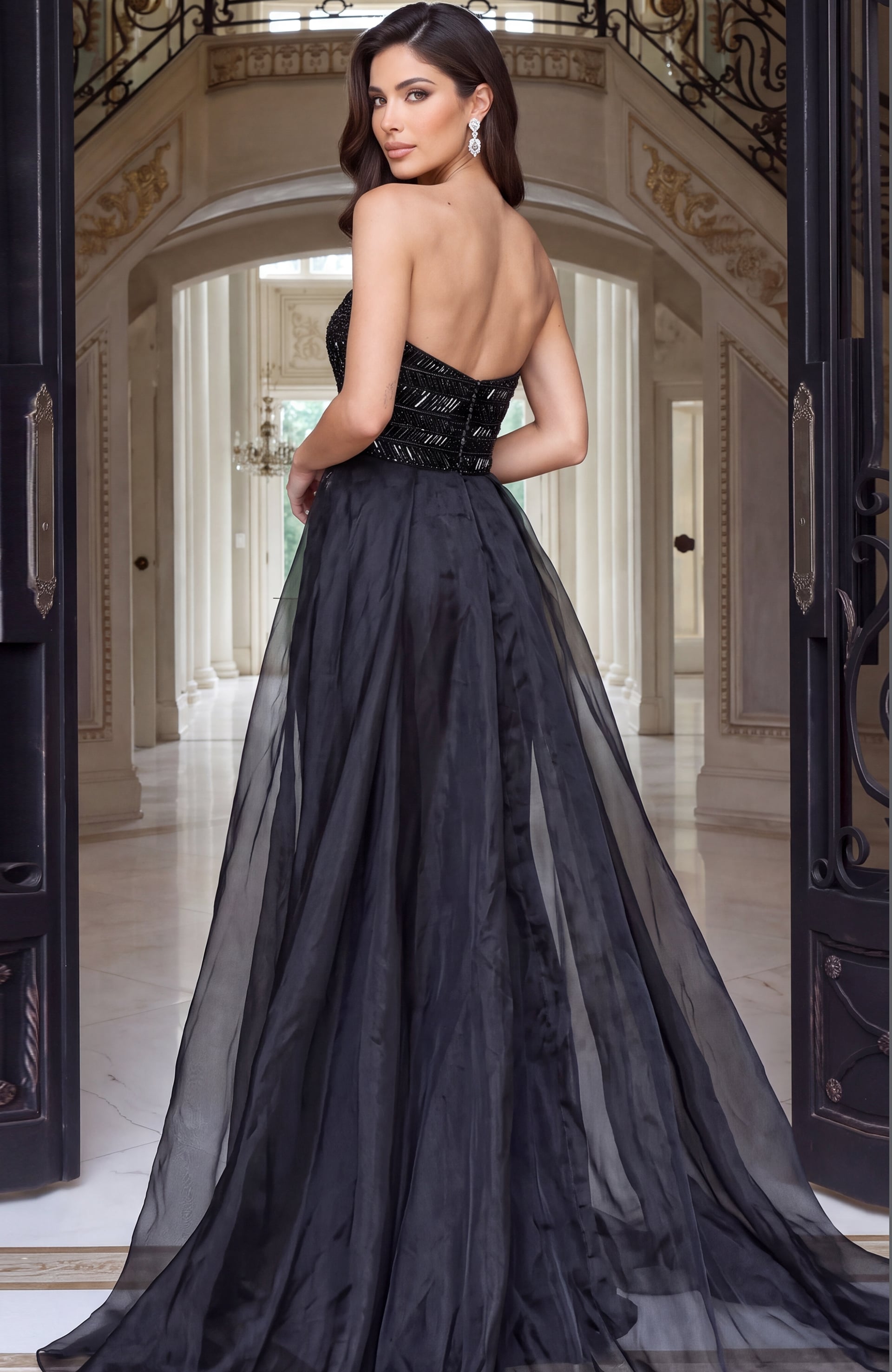 Back of a strapless black beaded gown layered under a sheer organza overskirt
