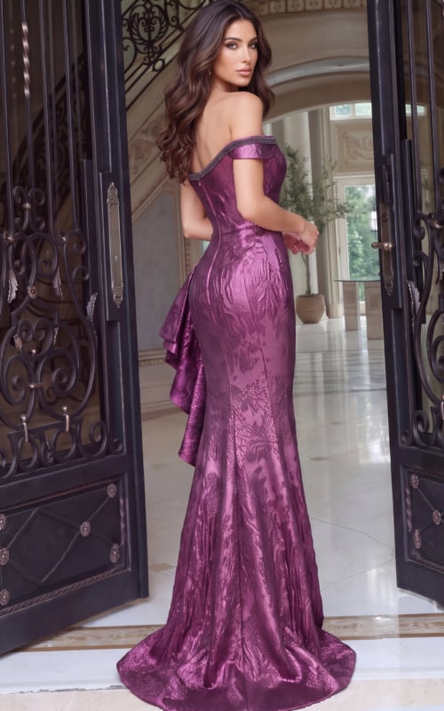 The back of a magenta metallic jacquard gown, off-shoulder band above a fishtail train