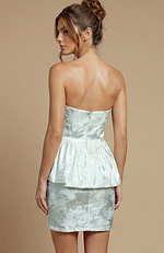 Modern strapless attire in a dense floral weave, blending a minimalist top with a bold, layered waist feature.