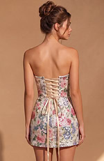 Sleeveless party dress with a structured bodice and a detailed corset-style back with metal grommets and crisscross ties.