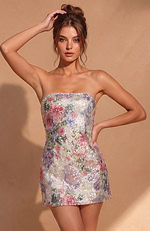 Short sequin dress showcasing a botanical garden pattern in shades of rose pink, lavender, and sage green.