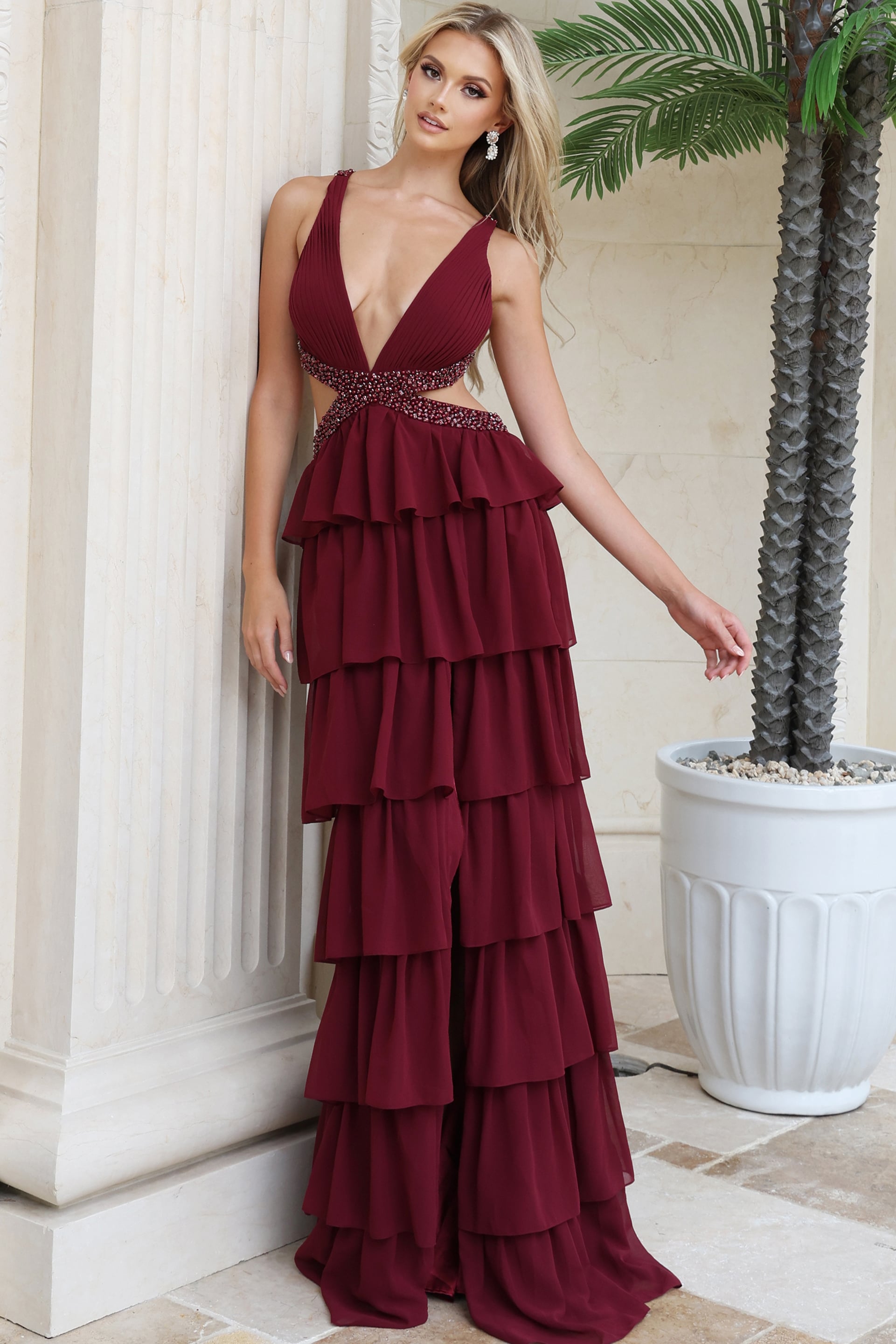 Burgundy tiered ruffle chiffon gown showing side waist cutouts and beaded trim