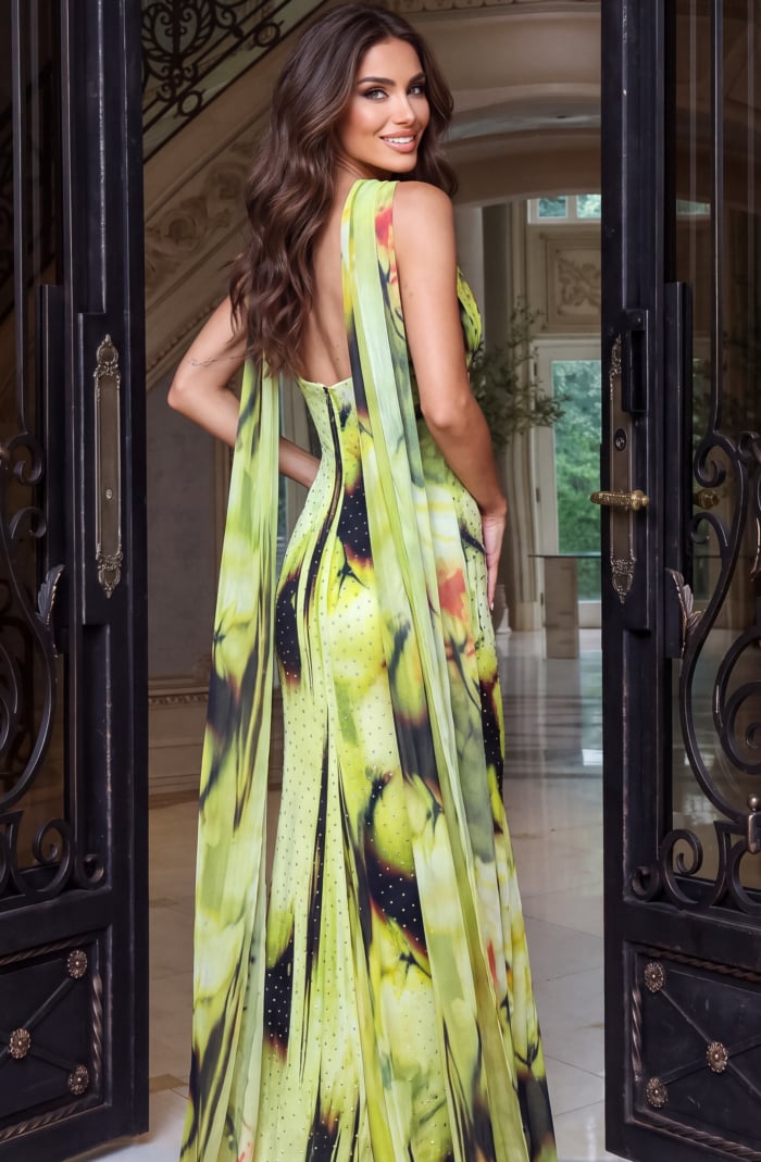 Cascading chiffon falls past the low open back of a citrus floral gown, photographed from the rear